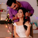 young-beautiful-couple-man-hanging-christmas-balls-ears-her-girlfriend-having-fun-christmas-decorated-room-with-christmas-tree-background