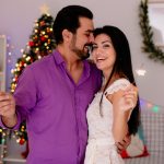 young-beautiful-couple-man-woman-with-sparklers-standing-each-other-happy-love-celebrating-christmas-together-decorated-room-with-christmas-tree-background